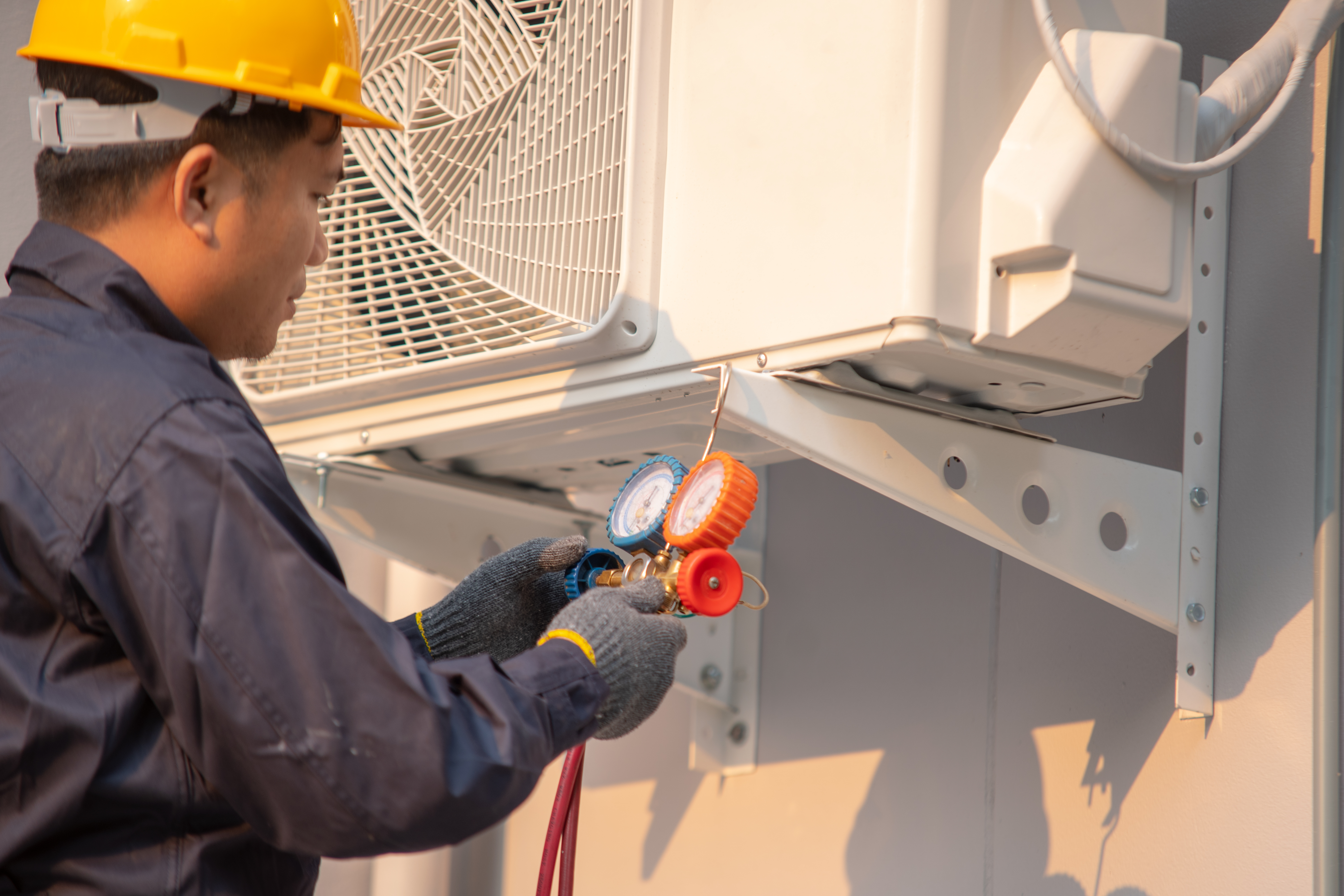 HVAC tech inspecting unit