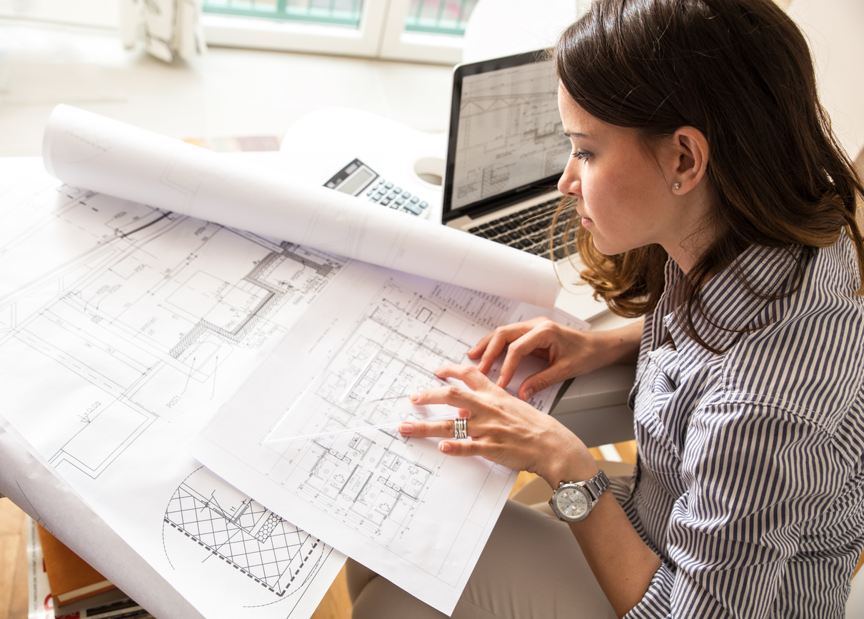 Woman looking over some architectural plans