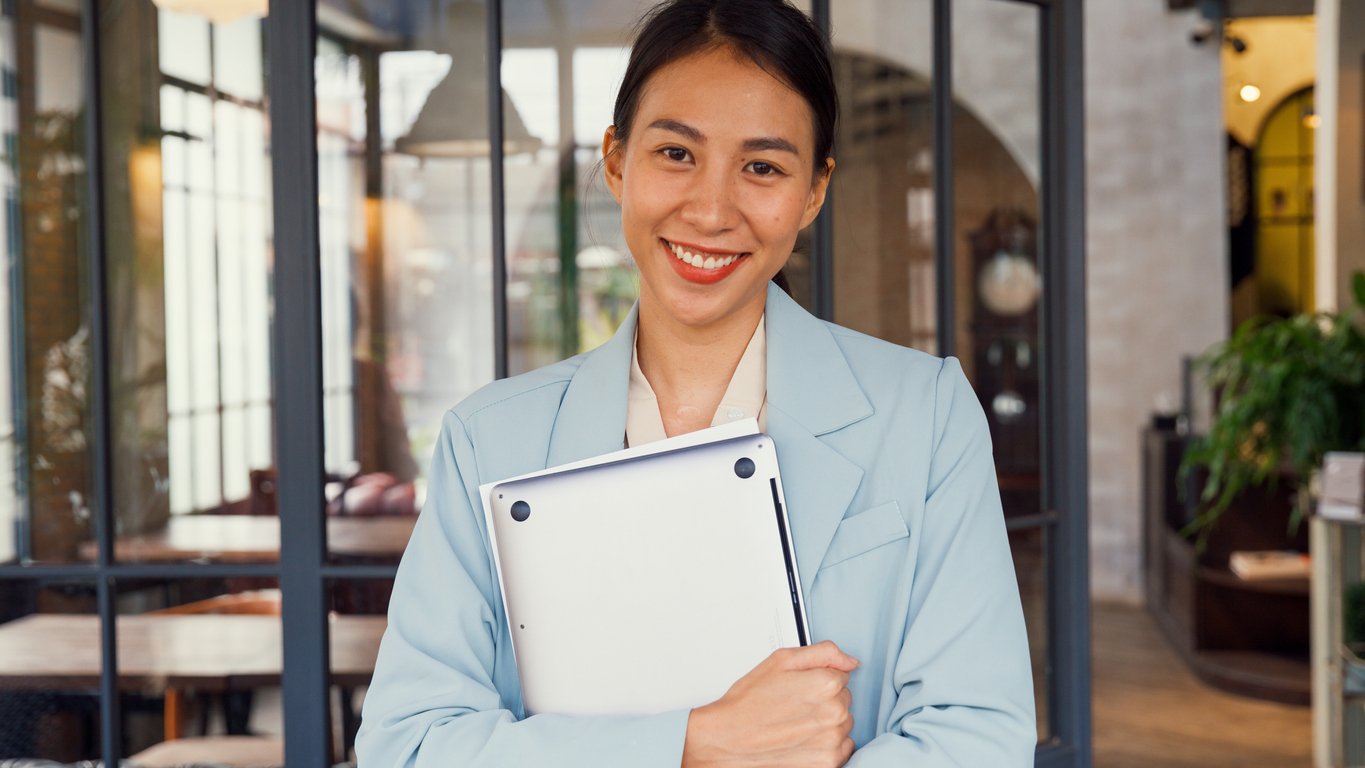 Legal assistant smiling while holding tablet