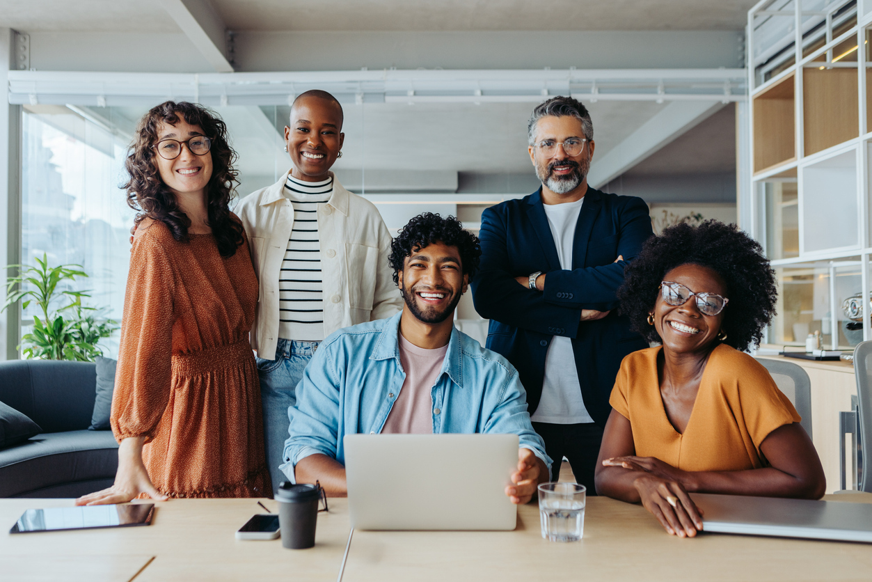 Group of technology professionals smiling in an office
