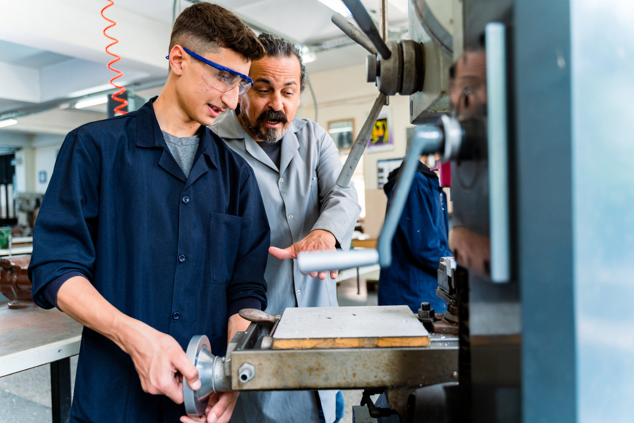 Student in vocational training with teacher